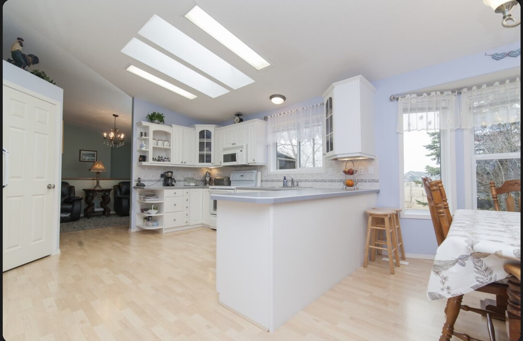Bright modern white kitchen interior with natural light